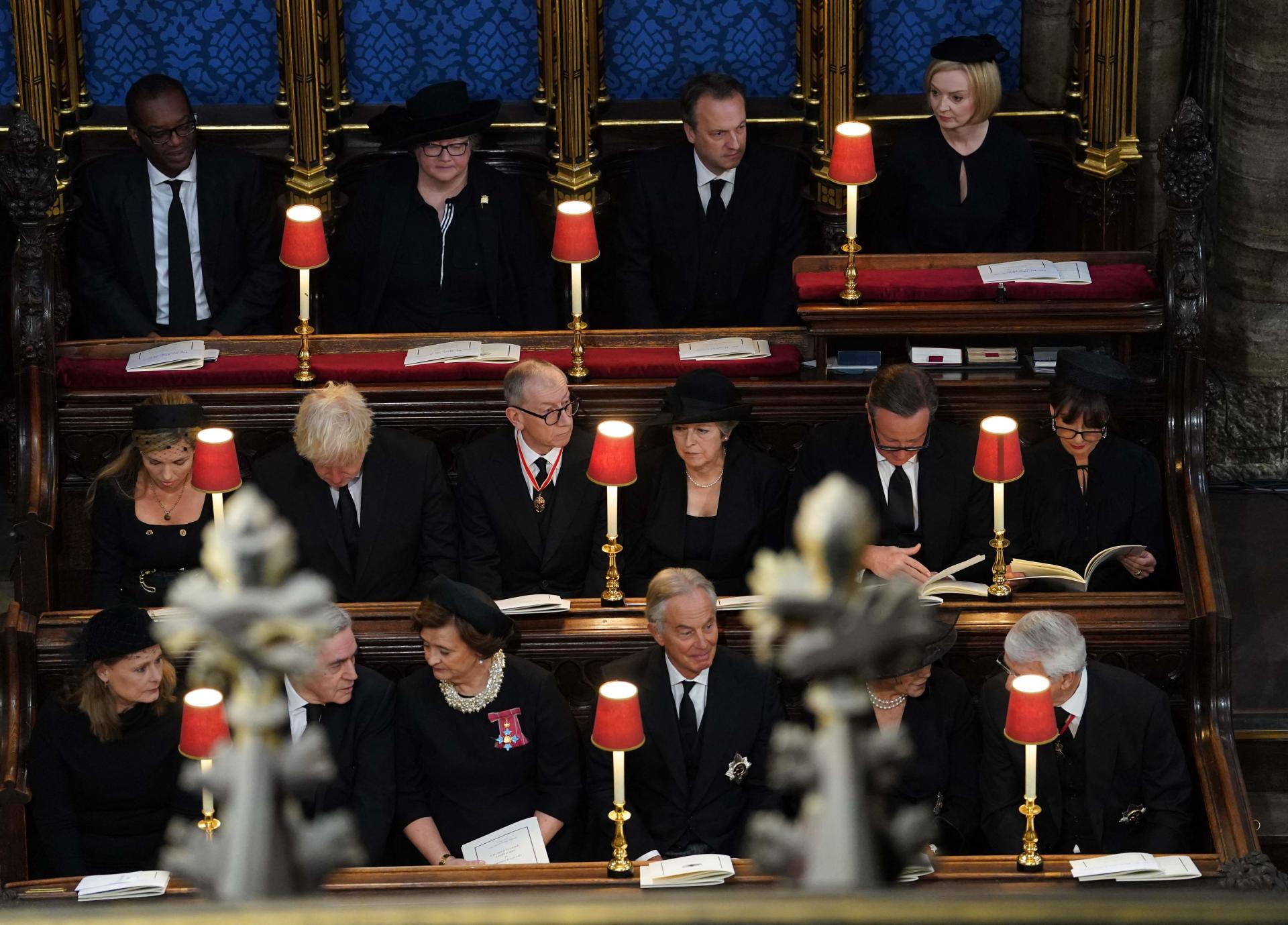 (Top row left to right) Chancellor of the Exchequer Kwasi Kwarteng, Deputy Prime Minister Dr Therese Coffey, Hugh O'Leary, Prime Minister Liz Truss, (middle row left to right) Carrie Johnson, Boris Johnson, Philip May, Theresa May, David Cameron, Samantha Cameron, (bottom row left to right) Sarah Brown, Gordon Brown, Cherie Blair, Sir Tony Blair, Lady Norma Major and Sir John Major, attending the State Funeral of Queen Elizabeth II, held at Westminster Abbey, London. (Photo by Gareth Fuller / POOL / AFP)