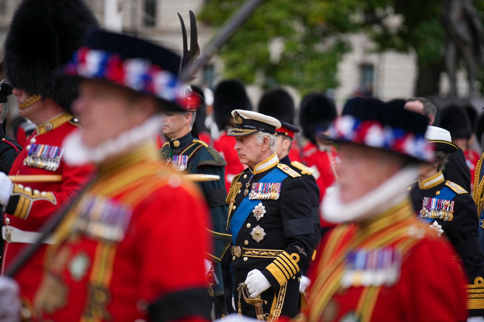 TOPSHOT - King Charles III follows a gun carriage carrying the coffin of Queen Elizabeth II during her funeral service in Westminster Abbey in central London Monday Sept. 19, 2022. The Queen, who died aged 96 on Sept. 8, will be buried at Windsor alongside her late husband, Prince Philip, who died last year. (Photo by Emilio Morenatti / POOL / AFP)